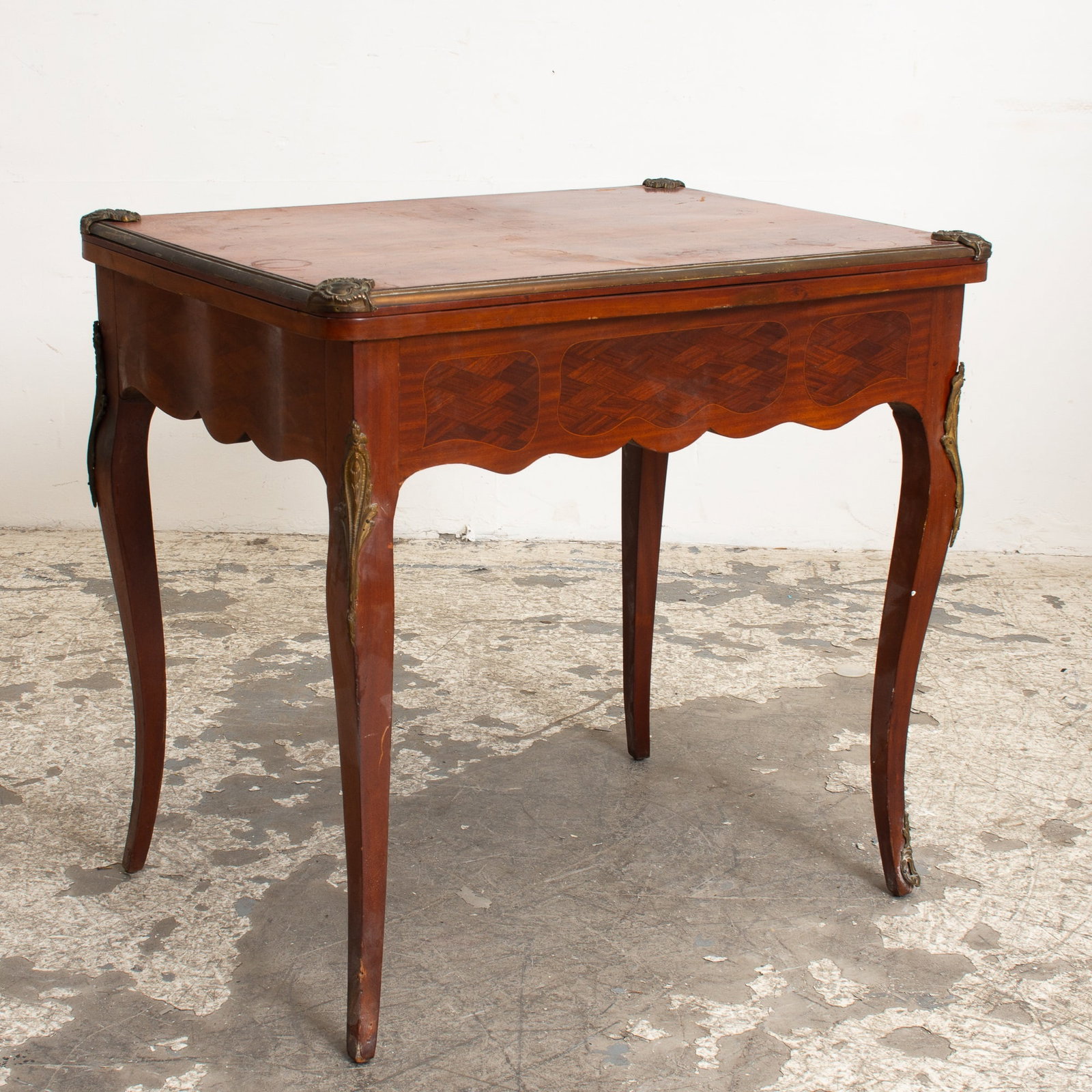 French Marquetry Games Table: With a single drawer and brass mounts (30" h x 32" w x 23" d Open 45 3/4" w) Scratches and dings, minor loss to veneer, missing two corner brackets