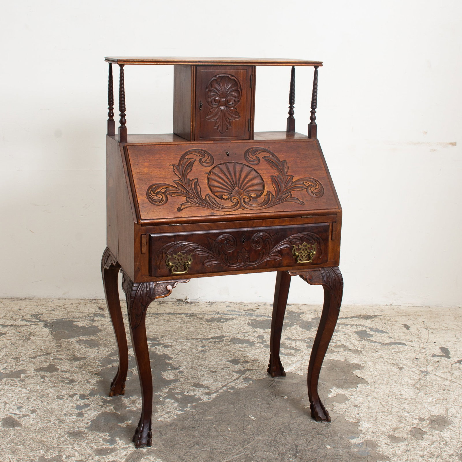 Mahogany Slant Front Desk: With carved shell ornamentation (46" h x 26 1/2" w x 16 1/2" d) Crack, scratches and dings