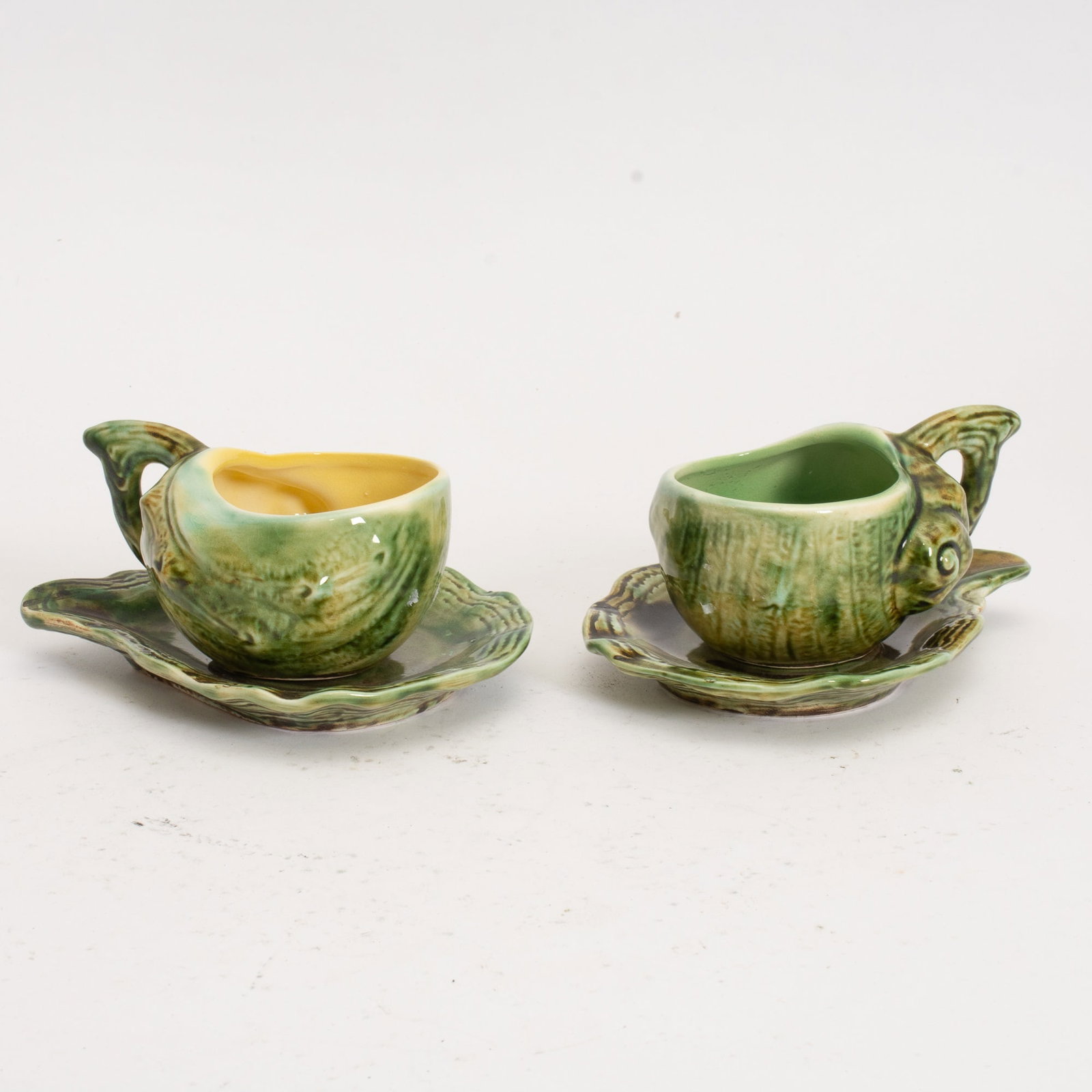 Pair of Majolica Cups and Saucers: . (Cup 2" h x 4 3/8" w x 3" d) Old repair to one