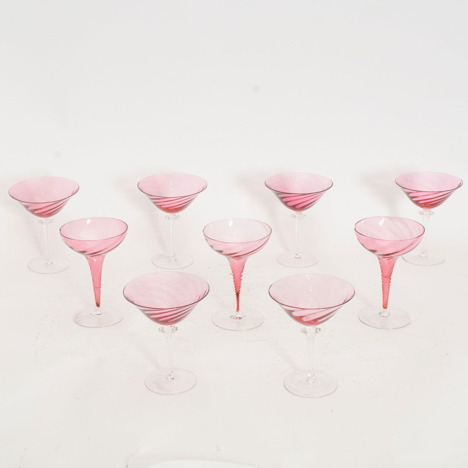 Set of Six Pink Martini Glasses;: Together with a set of three pink swirl stem martini glasses (5 1/2" h x 4 1/2" dia) Chip to one