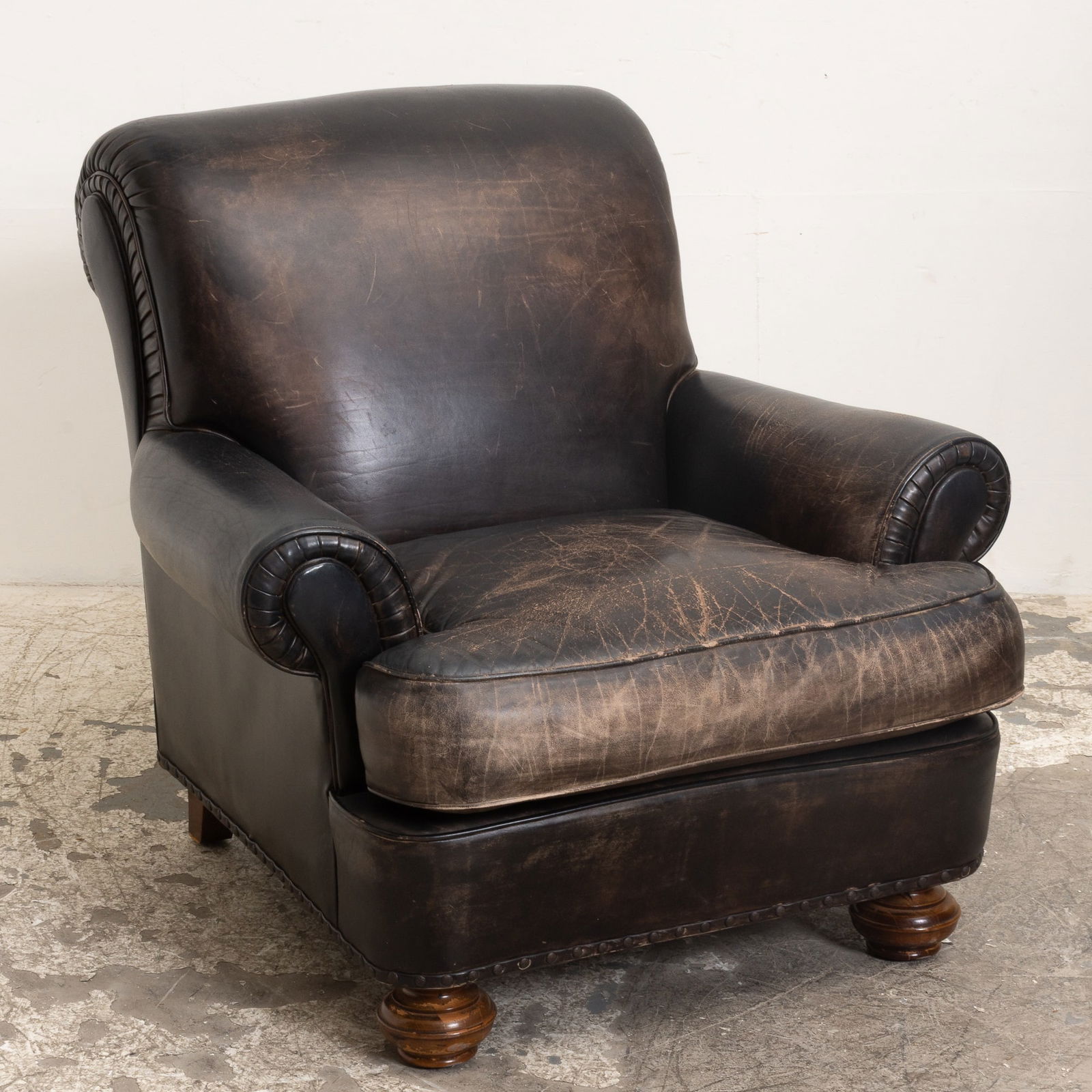 Brown Leather Upholstered Armchair: . (35" h x 38" w x 40" d Seat to floor 19" h) Overall wear