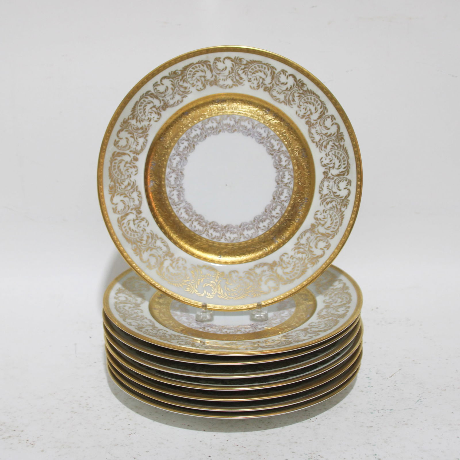Set of Eight Gold-Rimmed Dinner Plates: . (11" dia) Loss to gilt