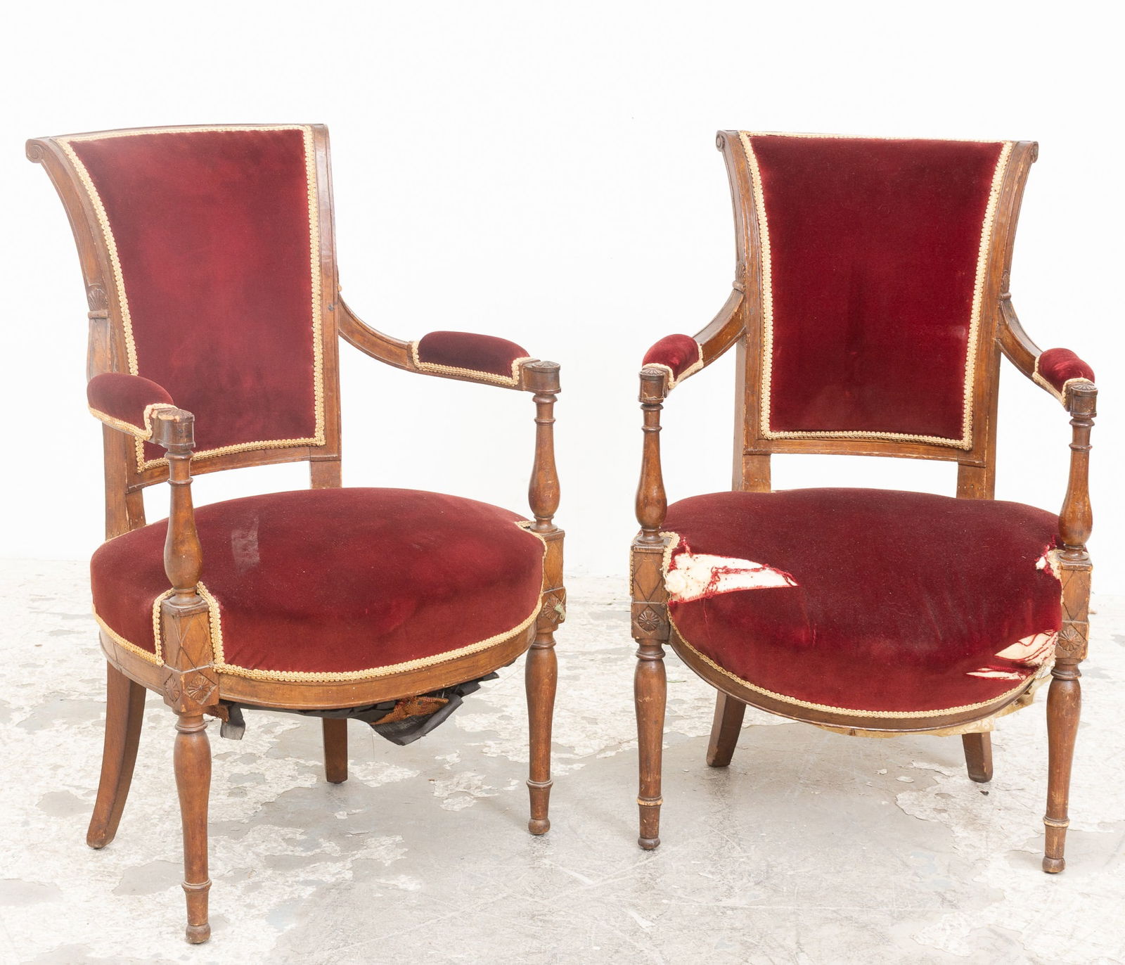 Pair of Directoire Upholstered Mahogany Fauteuils: . Edgewear, one with damaged seat rail and upholstery