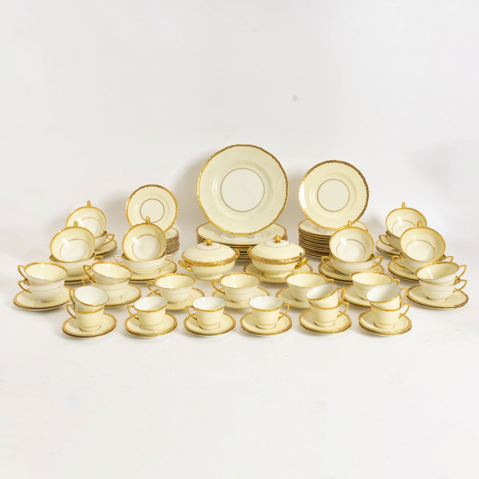 Royal Worcester Bone China Dinner Service: Comprising 11 soup cups, 10 teacups, 9 demitasse cups, 11 saucers, 12 demitasse saucers, 12 soup saucers, 11 bread plates, 13 salad plates, 9 dinner plates, 2 tureens (Dinner Plates 11" dia) Chips to