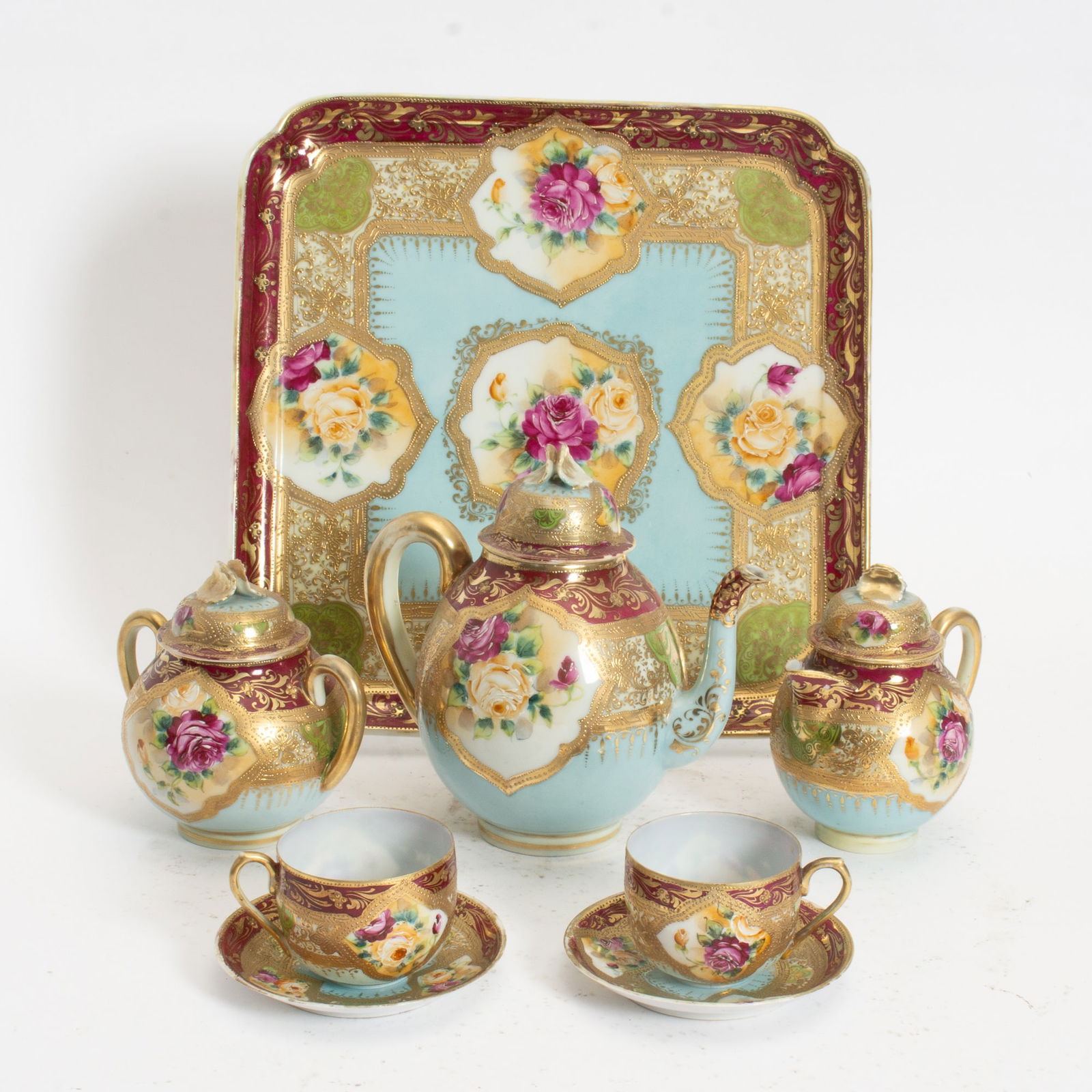 Chinese Bone China Tea Service: Comprising teapot, tray, sugar jar, creamer, 2 cups and saucers (Teapot 8" h Tray 14 1/4" square) Loss to finish