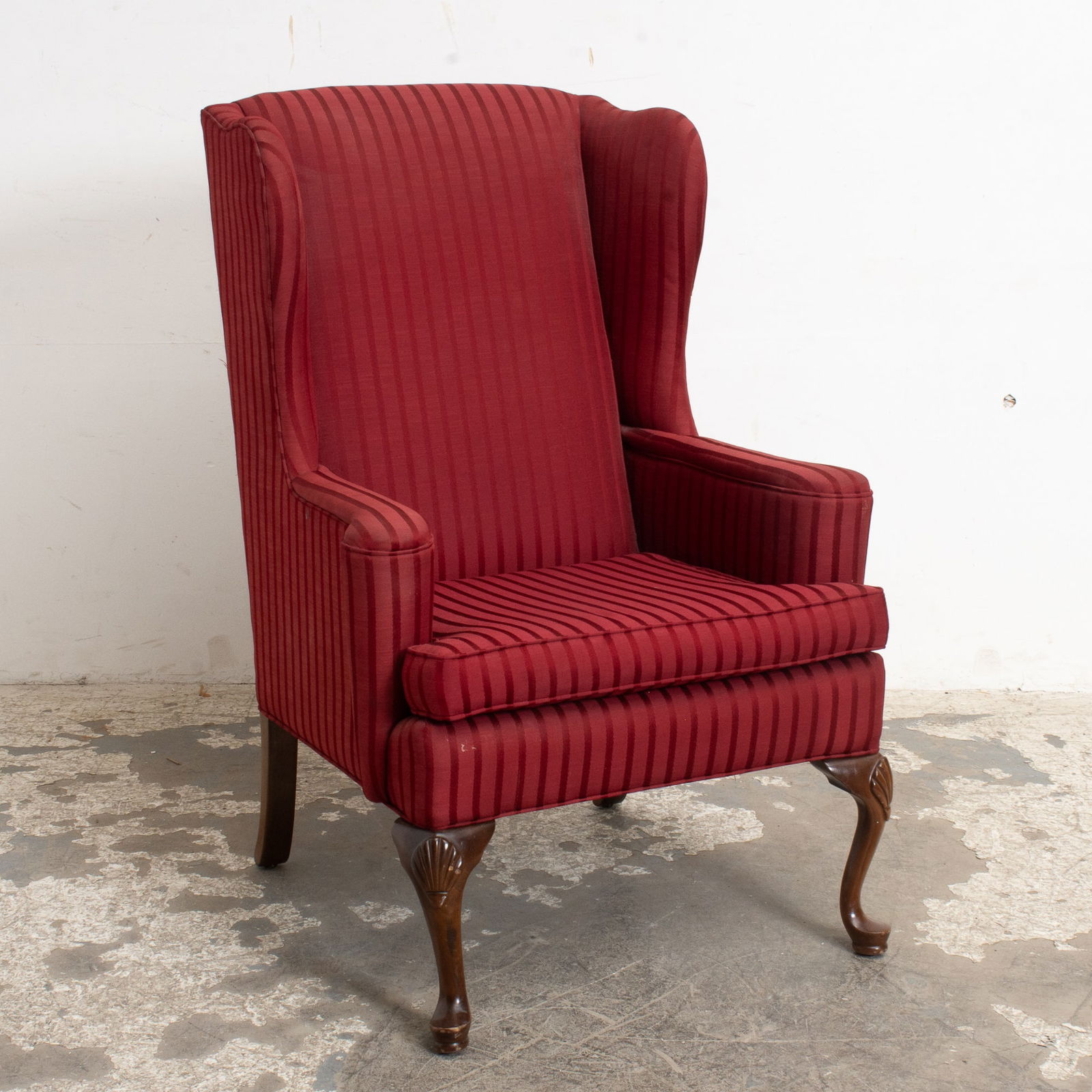 Red Upholstered Wingback Chair: With mahogany legs (34" h x 31" w x 32" d Seat to floor 20" h) Scratches and dings to legs