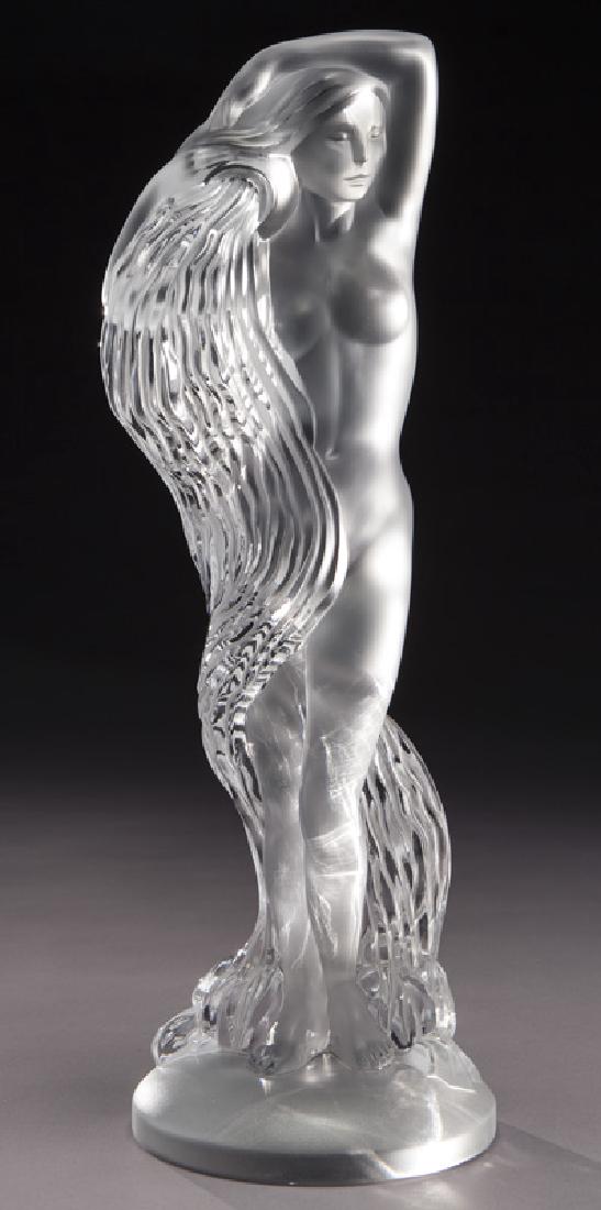 Lalique crystal figure of standing nude female.: Lalique crystal figure of standing nude female. Underside etched, "Lalique France 409/999". 17.625"H x 5.5"W, Circa - 20th C.PROVENANCE:Property from the collection of Mr. Kenneth W. Davis, Fort Worth