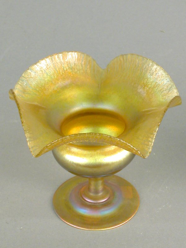 Tiffany flower form bulbous gold Favrile: Tiffany flower form bulbous gold Favrile body with a ruffled stretch rim. Signed "1529-8146M L C Tiffany Inc." Reference "Tiffany Favrile Glass" by Steeg, page 51, 4.5"h. ($1000-1500)