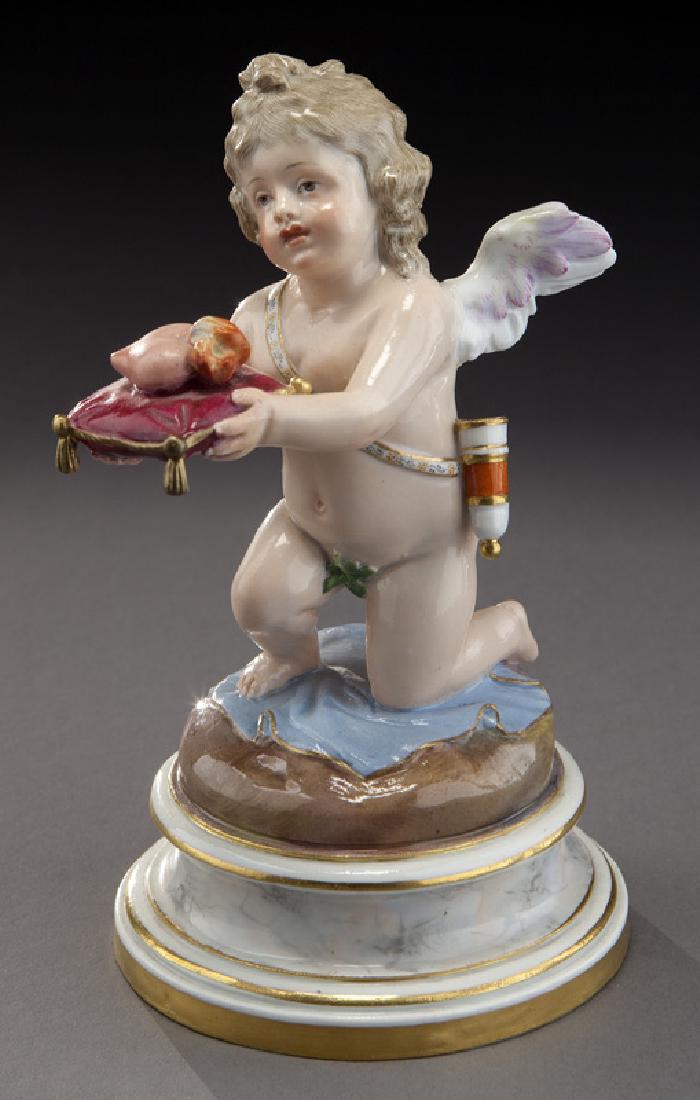 Meissen porcelain kneeling cupid: Meissen porcelain kneeling cupid holding out a heart on a pillow, on a gilt trimmed circular base with a faux marble finish. With crossed swords mark in blue underglaze and impressed "L122". 6.375"H,
