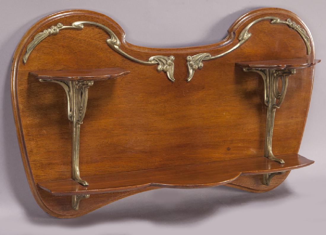 Art Nouveau mahogany and ormolu wall shelf: Art Nouveau mahogany and ormolu wall shelf with three shelves and ormolu fruiting vine decoration. 14.5"H x 24.5"W x 5.5"D, Circa - 1900. PROVENANCE: Property from the collection of Mr. Kenneth W. Dav