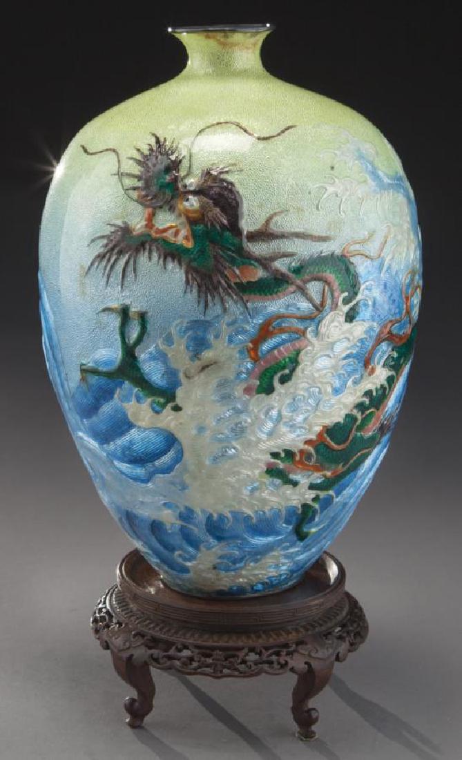 Japanese enameled silver vase: Japanese enameled silver vase with raised decoration depicting a sea dragon, waves and sea foam on a body going from yellow to pale blue. 9.75"H, Circa - 1900. PROVENANCE: Property from the collection