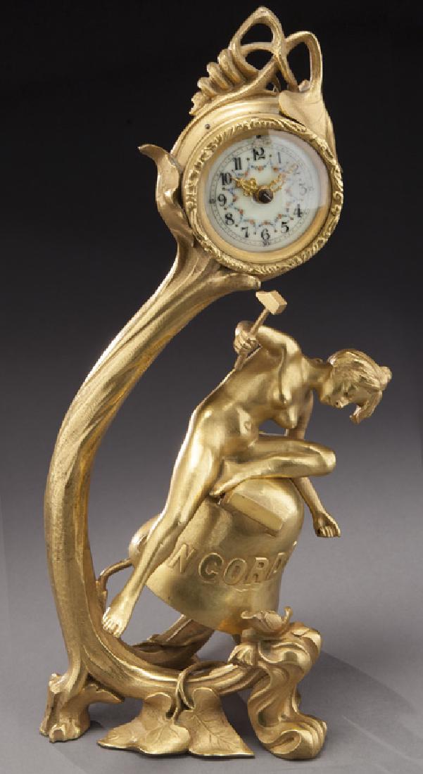 Art Nouveau gilt bronze shelf clock: Art Nouveau gilt bronze shelf clock with nude female figure holding a hammer and sitting on a bell marked, "CONCORDIA", in a floral and vine decorated scrolling stand holding the time only balance whe