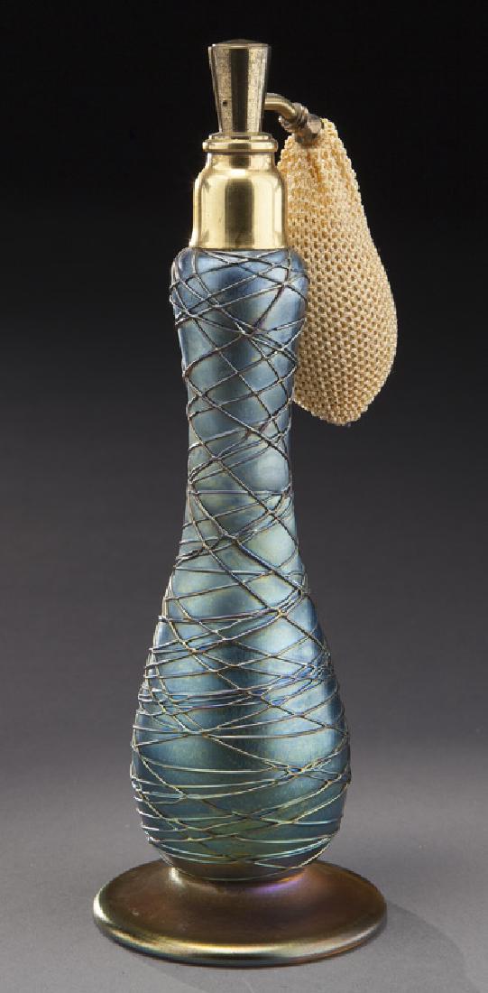 Art glass perfume bottle in gourd shape: Art glass perfume bottle in gourd shape with applied gold linear design, with atomizer. Probably by Durand. 7.5"H, Circa - Early 1900's. PROVENANCE: Property from the collection of Mr. Kenneth W. Davi