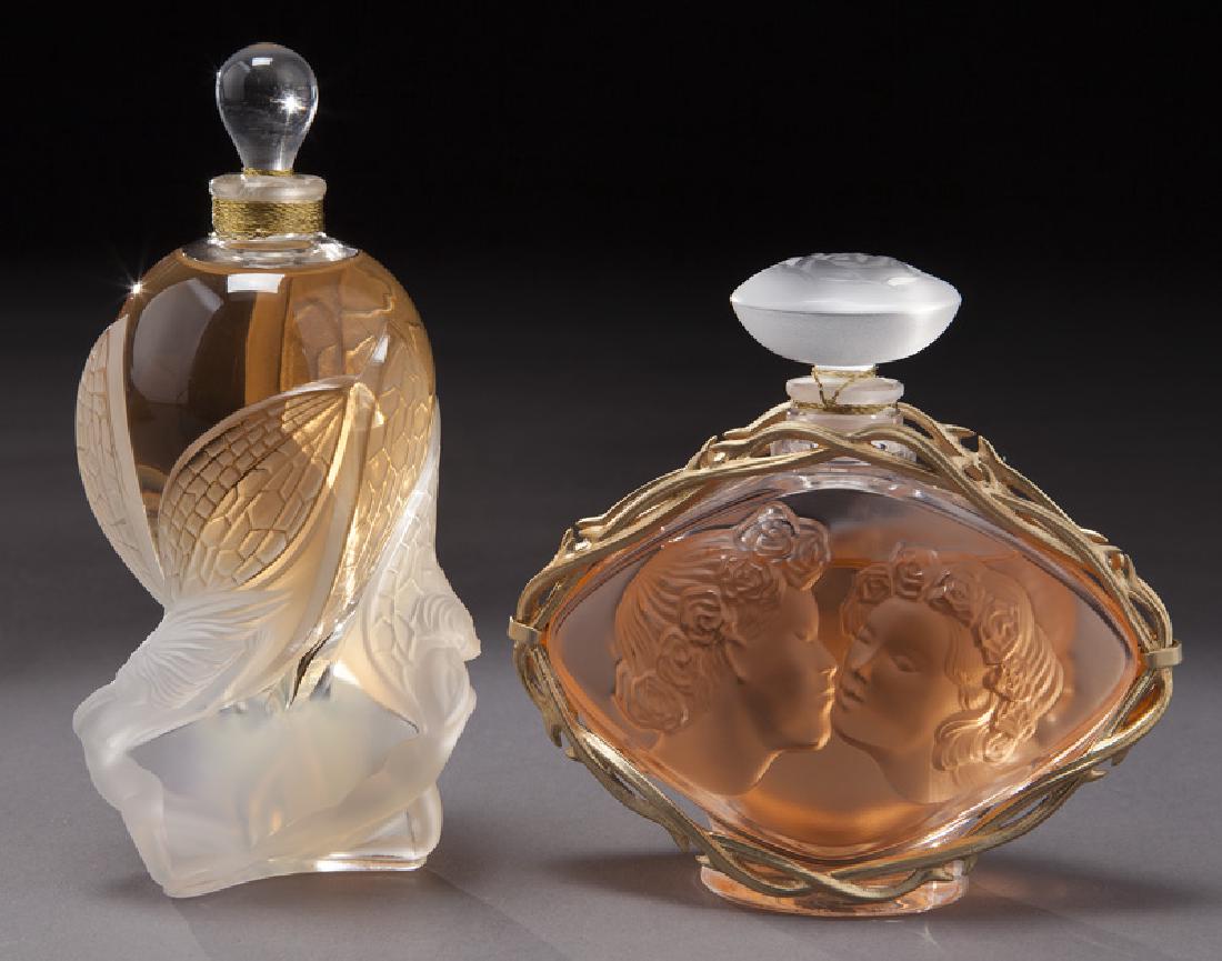 (2) Lalique glass perfume bottles,: (2) Lalique glass perfume bottles, comprising: (1) Lalique "Le Baiser" bottle featuring two lovers in relief with gilt vine surround and rose stopper; (1) Lalique Flacon Collection "Les Elfes" bottle 