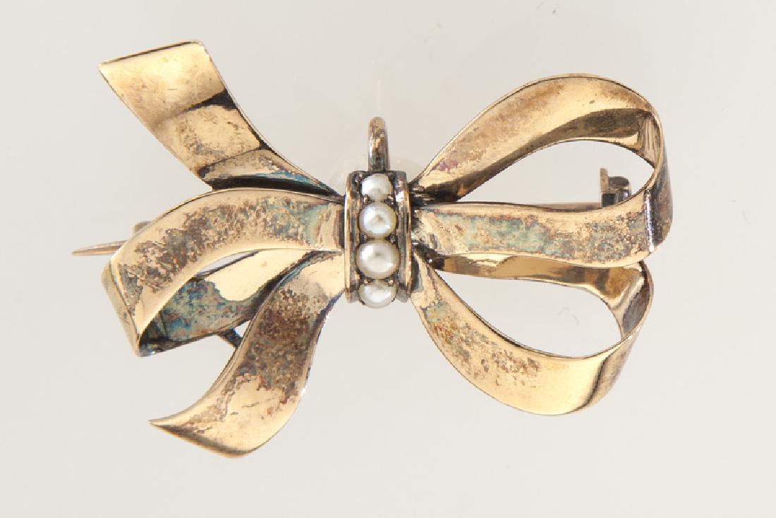 Edwardian/Deco 14K rose gold and pearl bow brooch: Edwardian/Deco 14K rose gold and pearl bow brooch featuring four seed pearls. Tested 14K. 4.9 grams. 1.25"L, Circa - Early 20th C. PROVENANCE: From the Estate of a Prominent Texas Businessman.