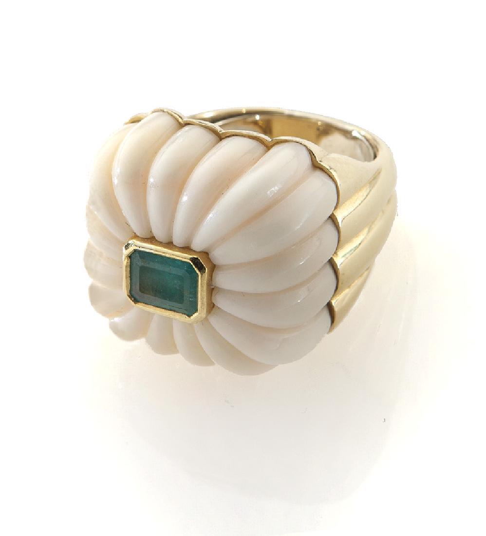 Andrew Clunn 18K gold, coral and emerald ring,: Andrew Clunn 18K gold, coral and emerald ring, featuring a central emerald cut emerald, .9 cts. approximate, mounted in a fluted angel hair coral, in 18K yellow gold mount fitted with a ring guard. St
