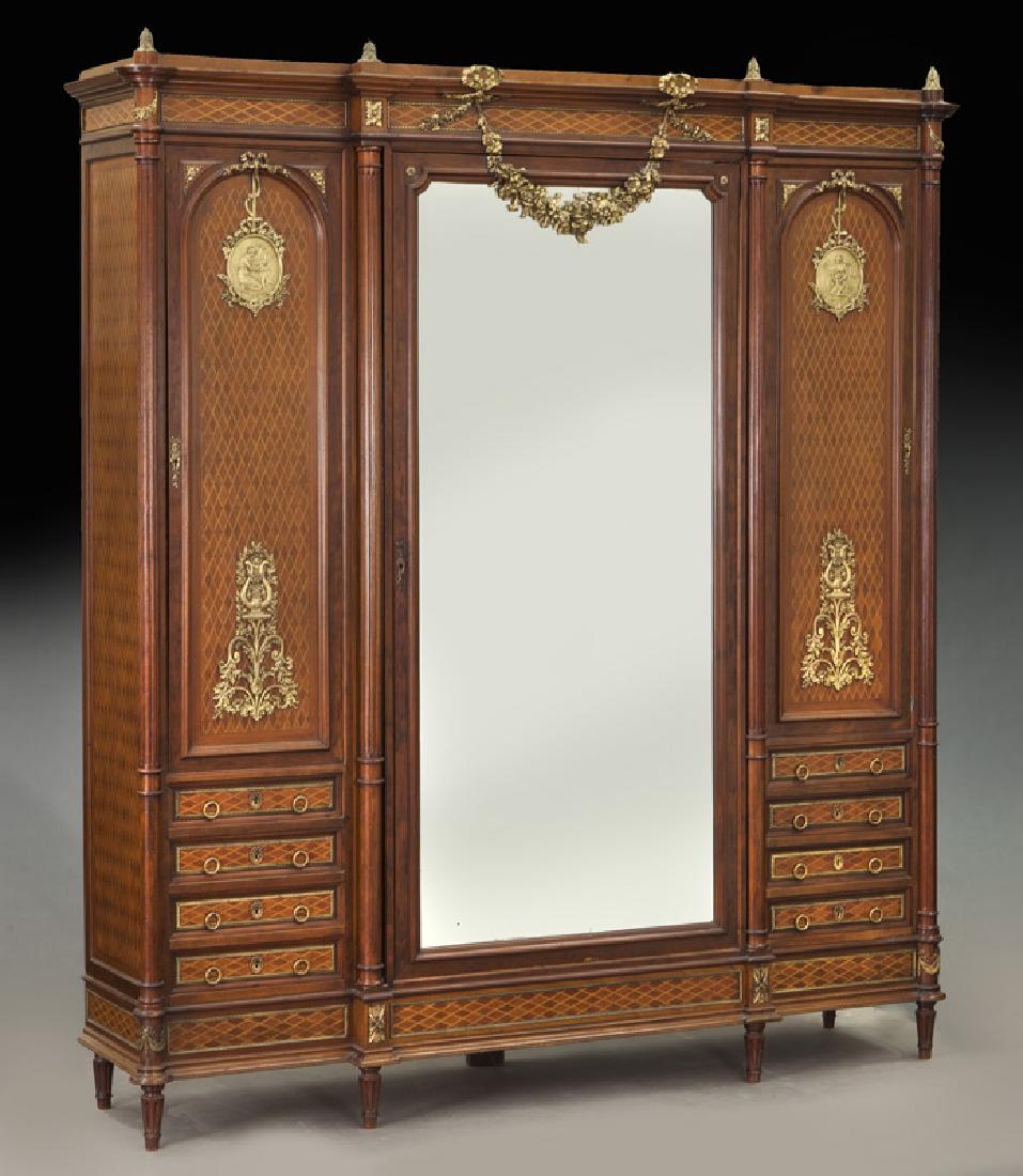 Mercier Freres Louis XVI style parquetry armoire: Mercier Freres Louis XVI style parquetry armoire having a break fronted cornice surmounted by bronze leaf-capped finials over a acajou and satine lozenge parquetry frieze, centered by a cast ribbon ti