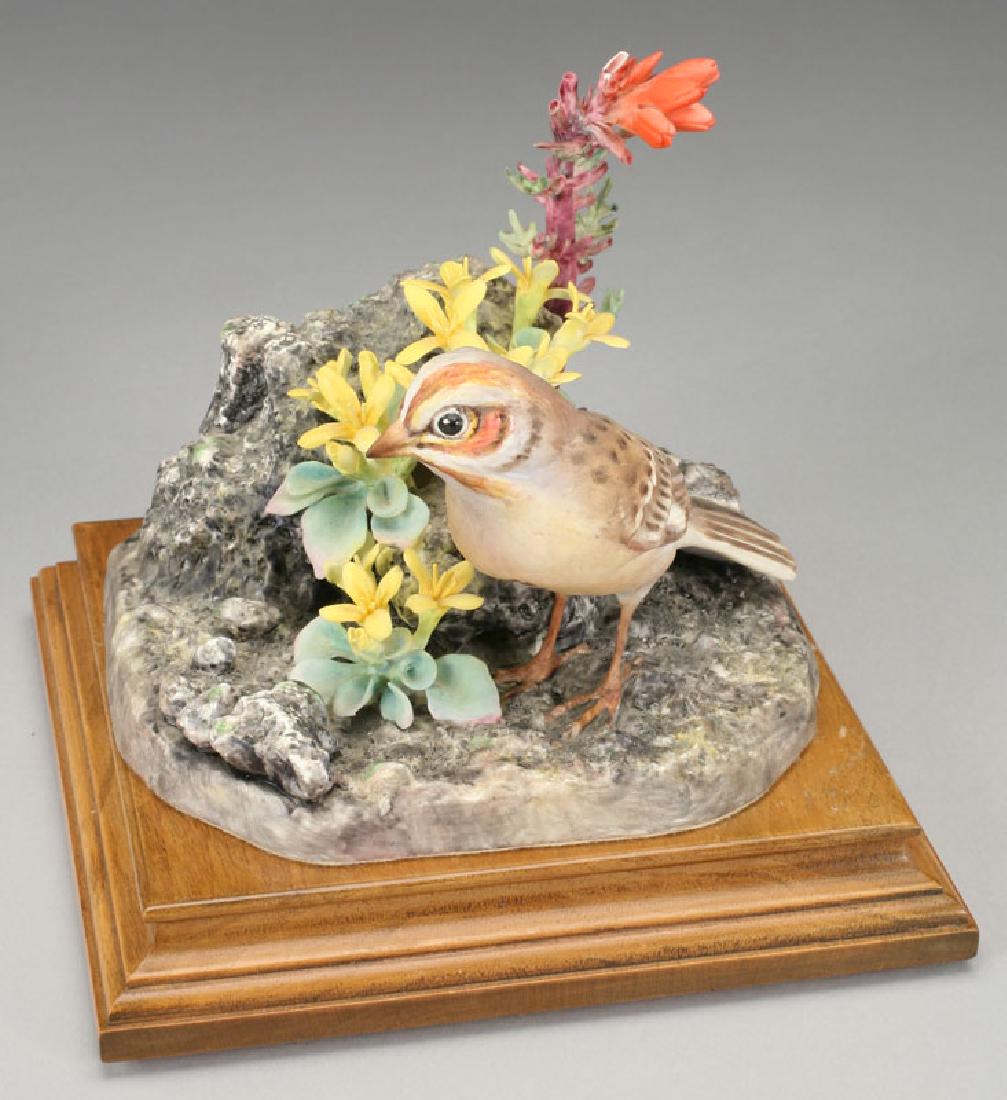 Dorothy Doughty porcelain bird, Lark Sparrow: Dorothy Doughty porcelain bird, Lark Sparrow with red gilt and twinpod growing in volcanic ash, on stand, bearing the black Royal Worcester mark, "England," stamp for 1966 and copyright 1966, and sign