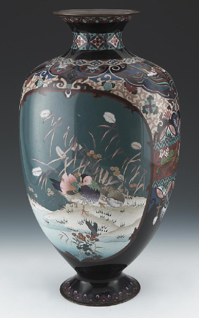 Japanese Meiji cloisonne vase: Japanese Meiji cloisonne vase depicting chrysanthemum, flowers and lucky symbols. 17.75"H, Late 19th C. CONDITION: Wear consistent with age and use. Circa -