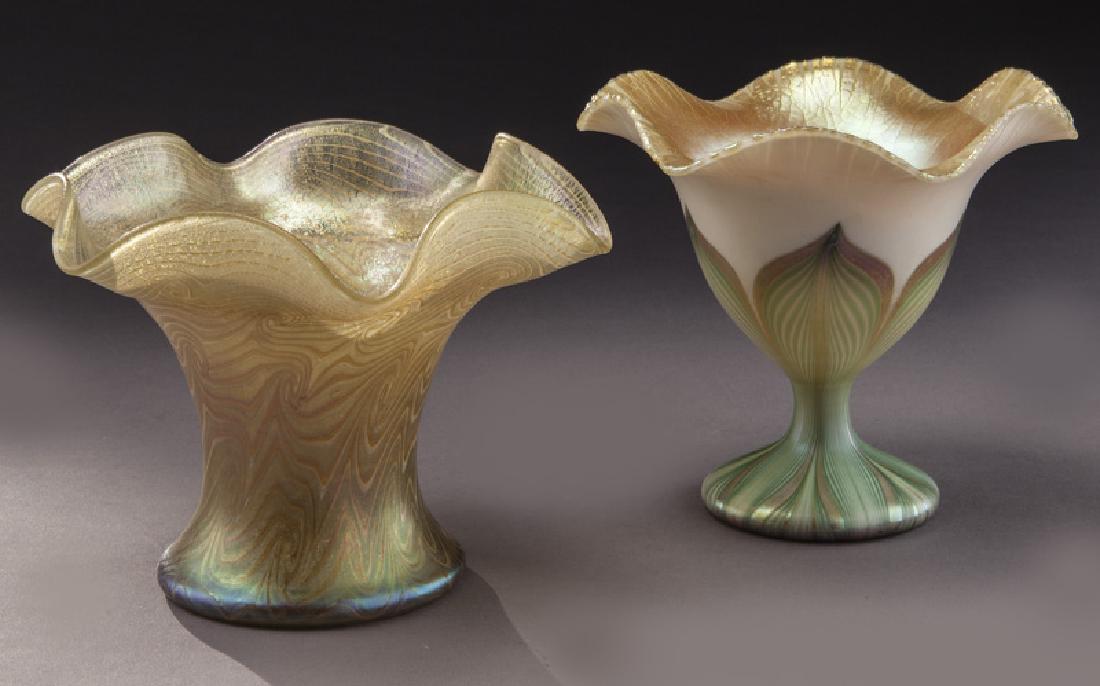 (2) Quezal art glass vases,: (2) Quezal art glass vases, including: (1) footed sweet pea with green pulled feather; (1) corset ruffled rim coup with King Tut design. Each signed, "Quezal". Taller: 5"H, Circa - 1920. PROVENANCE: F