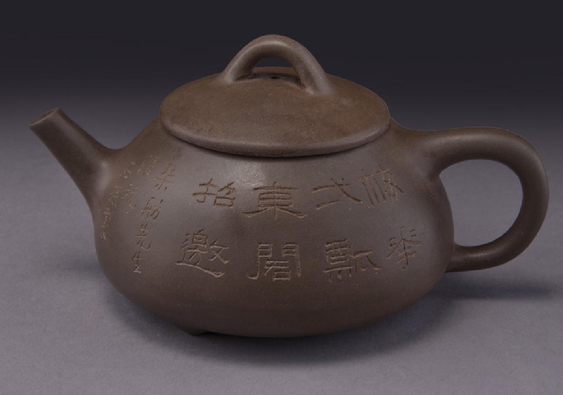 Chinese Qing Yixing teapot signed Zhu Shi Mei,: Chinese Qing Yixing teapot signed Zhu Shi Mei, one side depicting plum blossoms and the other with a poem and signature. Attributed to Zhu Shi Mei. Seal mark on base. 3.375"H x 6.5"L x 4.75"W, Circa -