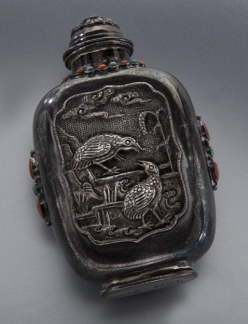 Chinese Mongolian silver snuff bottle: Chinese Mongolian silver snuff bottle with coral and turquoise inlay, depicting quail and landscape. 3.5"H, Circa - 19th C.