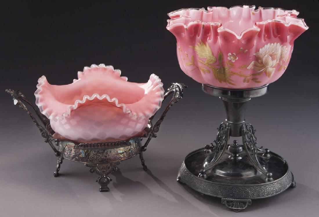 (2) Pink satin glass bride's baskets,: (2) Pink satin glass bride's baskets, including: (1) diamond quilted pink bowl set in a two handled embossed frame; (1) pink melon ribbed ruffle rim bowl with mums set in a columnar stand. Taller: 13"