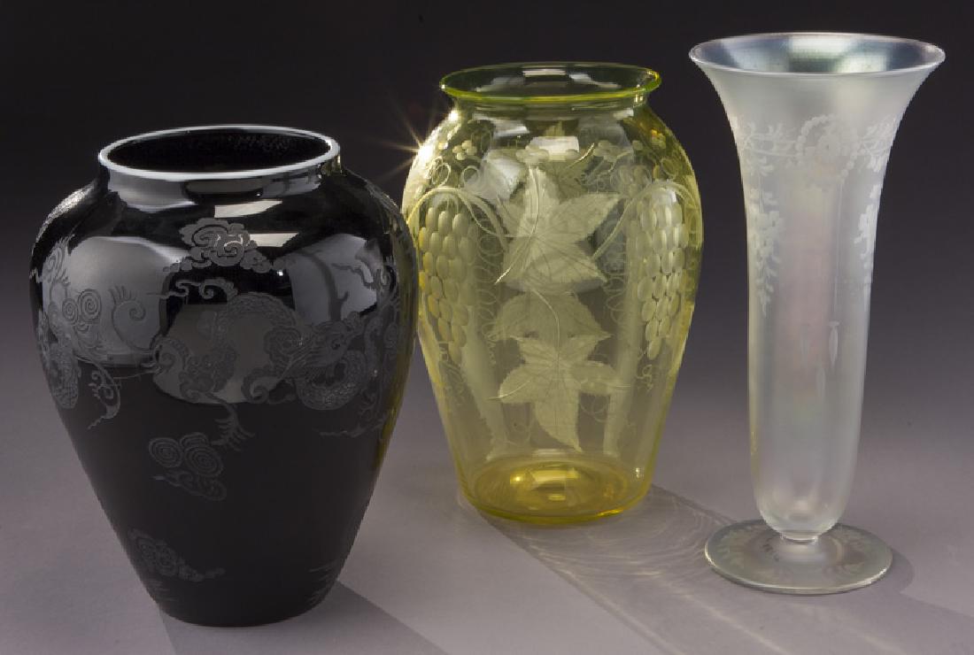 (3) American etched glass items,: (3) American etched glass items, including: (1) Sinclair mirror black vase with dragon motif; (1) Pairpoint vaseline vase with grape pattern; (1) Steuben footed Verre de Soie vase. Tallest: 10"H, Circ