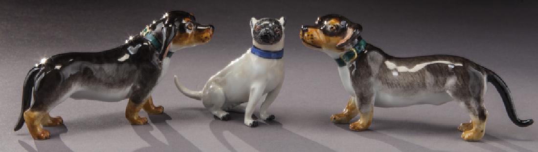 (3) Small Meissen porcelain dogs.: (3) Small Meissen porcelain dogs. With crossed sword mark in blue underglaze. 2.25"L, 3.5"L, 4"L, Circa - Early 1900's.