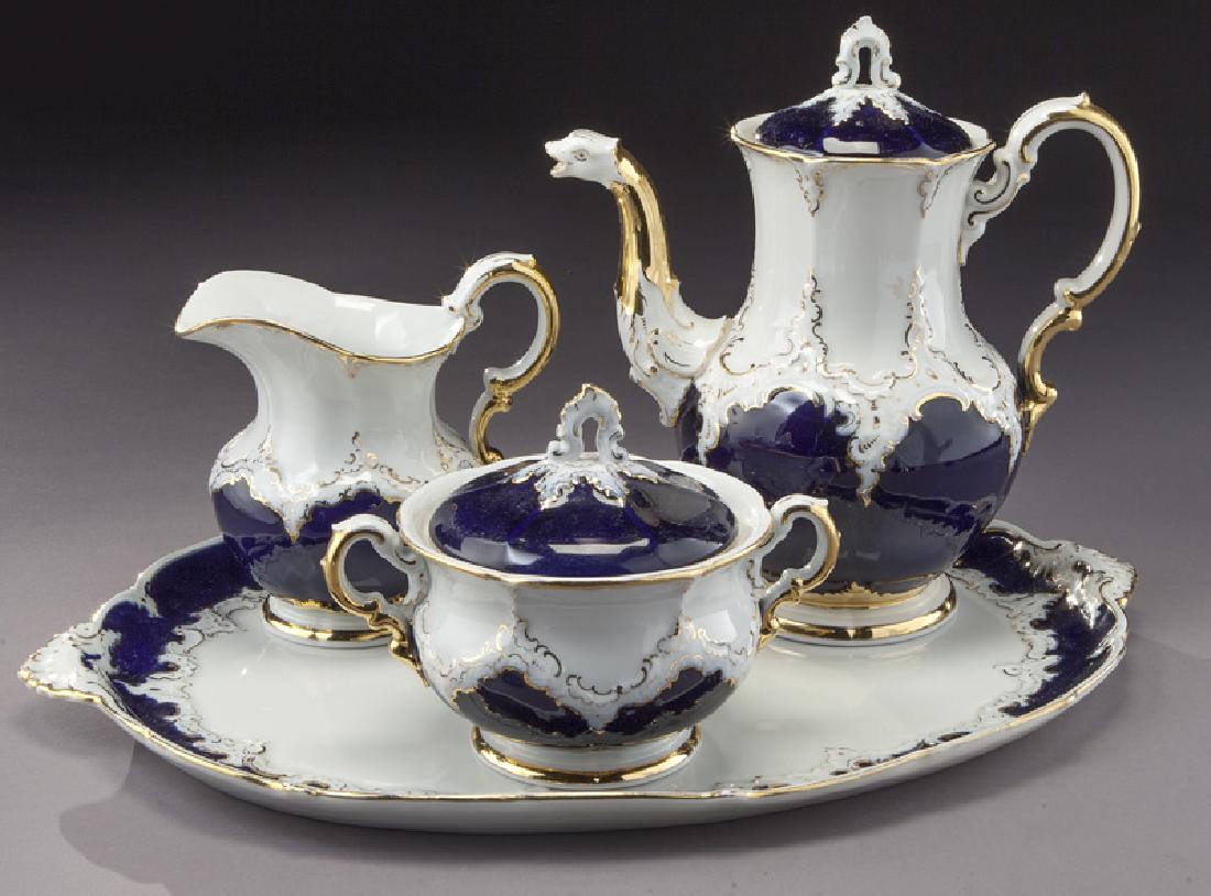 (4) Pc. Meissen coffee service with cobalt blue: (4) Pc. Meissen coffee service with cobalt blue and gilt decoration, including: (1) coffee pot; (1) creamer; (1) lidded sugar bowl and (1) oval tray. All with crossed swords mark in blue. Coffee pot: