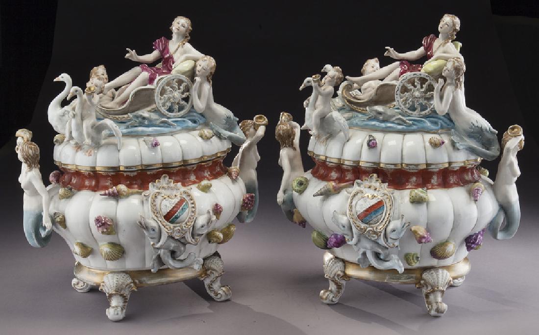 Pr. Meissen style figural porcelain tureens,: Pr. Meissen style figural porcelain tureens, the lids with a draped classical female atop a boat flanked by putti, swans and a mermaid over base with dolphin medallions and mermaid handles, all raised