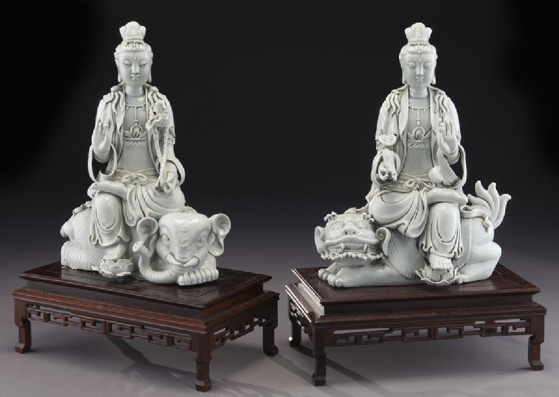 Pr. Chinese blanc de chine porcelain figure: Pr. Chinese blanc de chine porcelain figure of Guan Yin seated, one seated on elephant and the other on a lion, raised on carved wood bases. Guan Yin: 13"H x 9"W; Overall: 17"H x 11.5"W, Circa - 20th 
