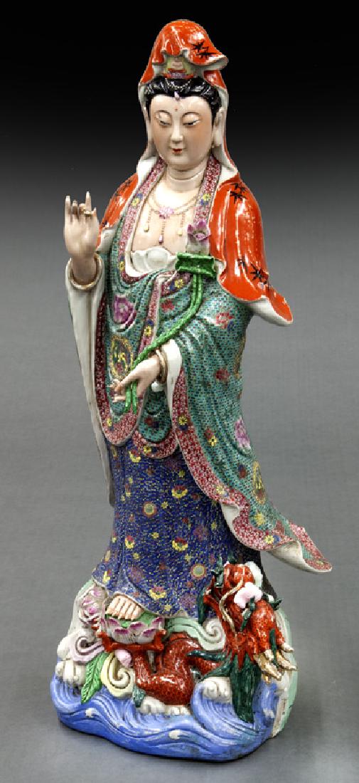 Lg. Chinese polychrome enamel porcelain Guan Yin: Lg. Chinese polychrome enamel porcelain Guan Yin standing atop a lotus and dragon. 40"H x 13"W x 10"D, Circa - 20th C.