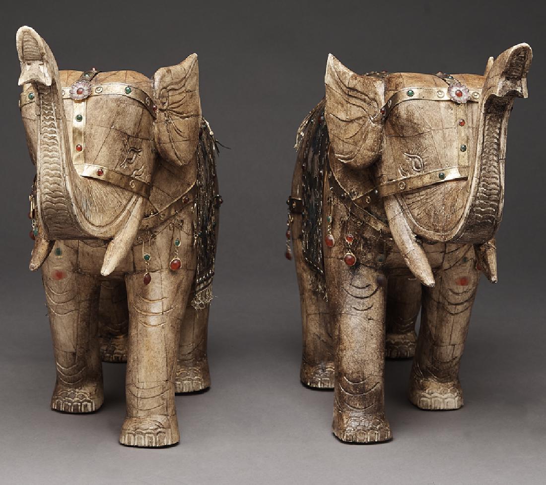 Pr. Chinese carved bone elephants: Pr. Chinese carved bone elephants with gilt and enameled mount, each with trunks raised and embellished with gilt metal and jeweled blanket and harness issuing drops. 19"H x 24.5"W, Circa - 20th C.