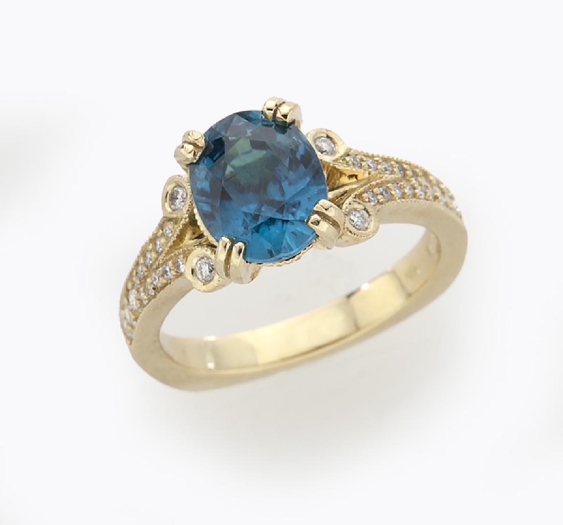 18K gold, diamond and zircon ring: 18K gold, diamond and zircon ring featuring an oval blue Zircon accented by round brilliant cut diamonds. Stamped, "18K Wixon". 7.7 grams. Size 7, Circa - 20th C.