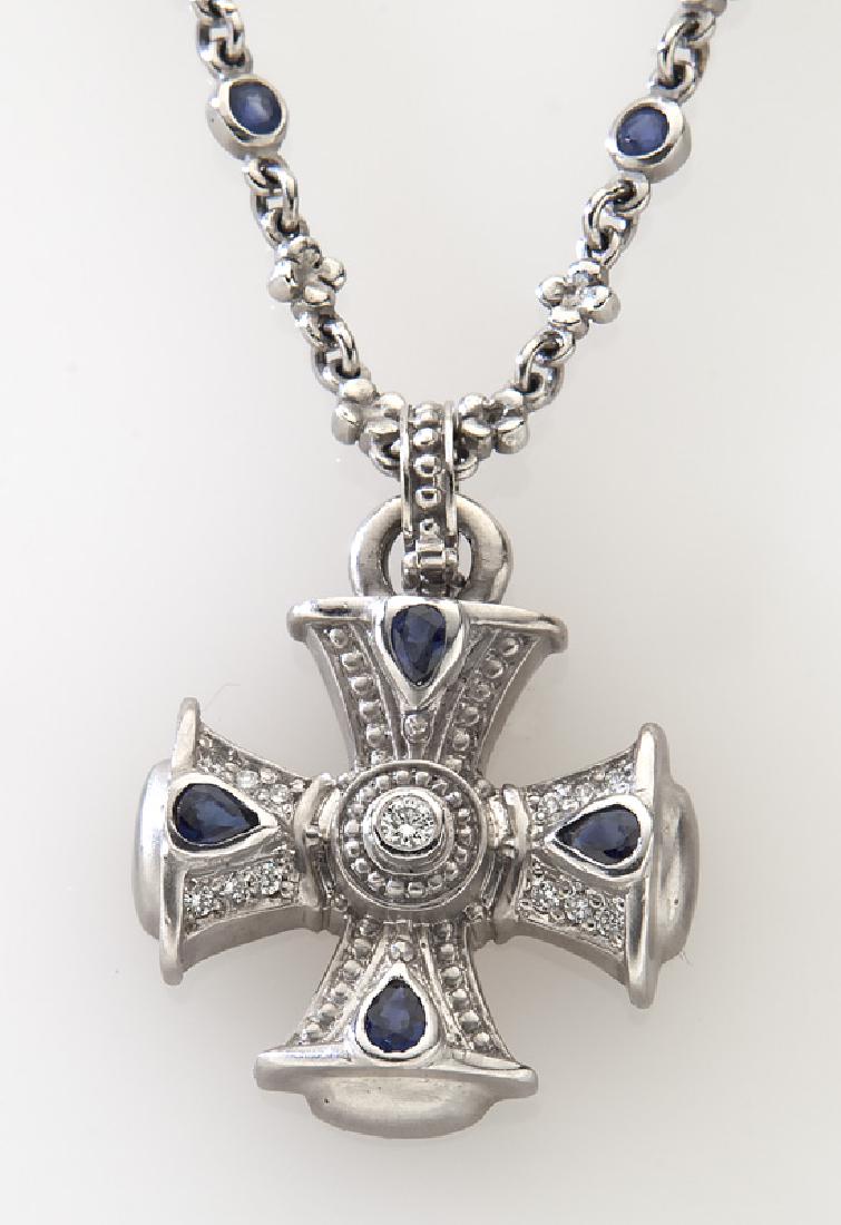 Judith Ripka 18K gold, diamond and sapphire cross: Judith Ripka 18K gold, diamond and sapphire cross with platinum chain, both mounted with sapphires and diamonds. Necklace stamped, "Judith Ripka 18K"; chain stamped, "Pt950". 41.6 grams. Chain: 18"L;