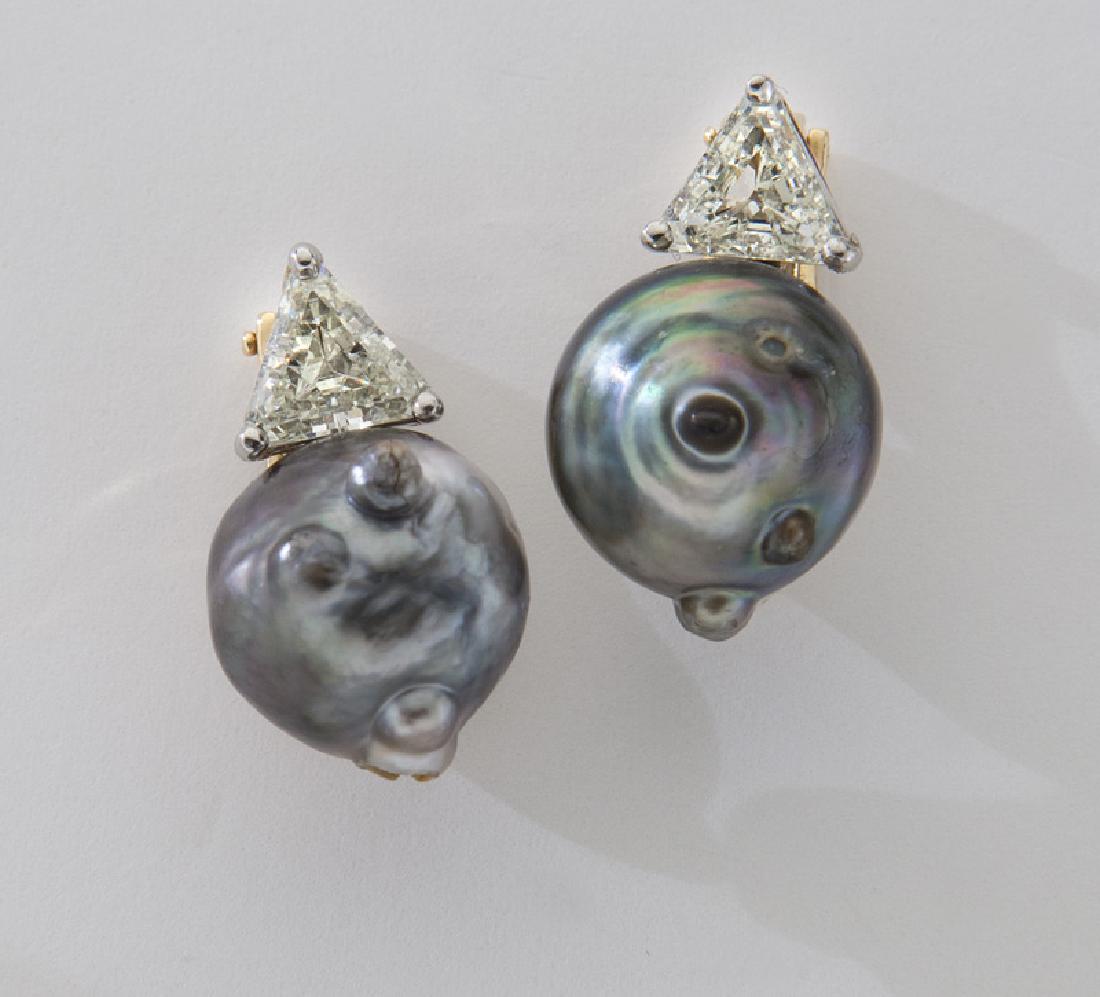 14K gold, Tahitian pearl and diamond earrings: 14K gold, Tahitian pearl and diamond earrings featuring a pair of grey/black pearls, 14-14.75mm, accented by triangular cut-cornered diamonds in 14K white and yellow gold mounts with clip backs. Stamp