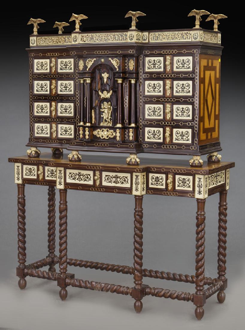 Spanish Renaissance style inlaid vargueno,: Spanish Renaissance style inlaid vargueno, the upper chest surmounted by eagles and a pierced gallery over central door with figural mounts revealing a fitted interior flanked by drawers and supported