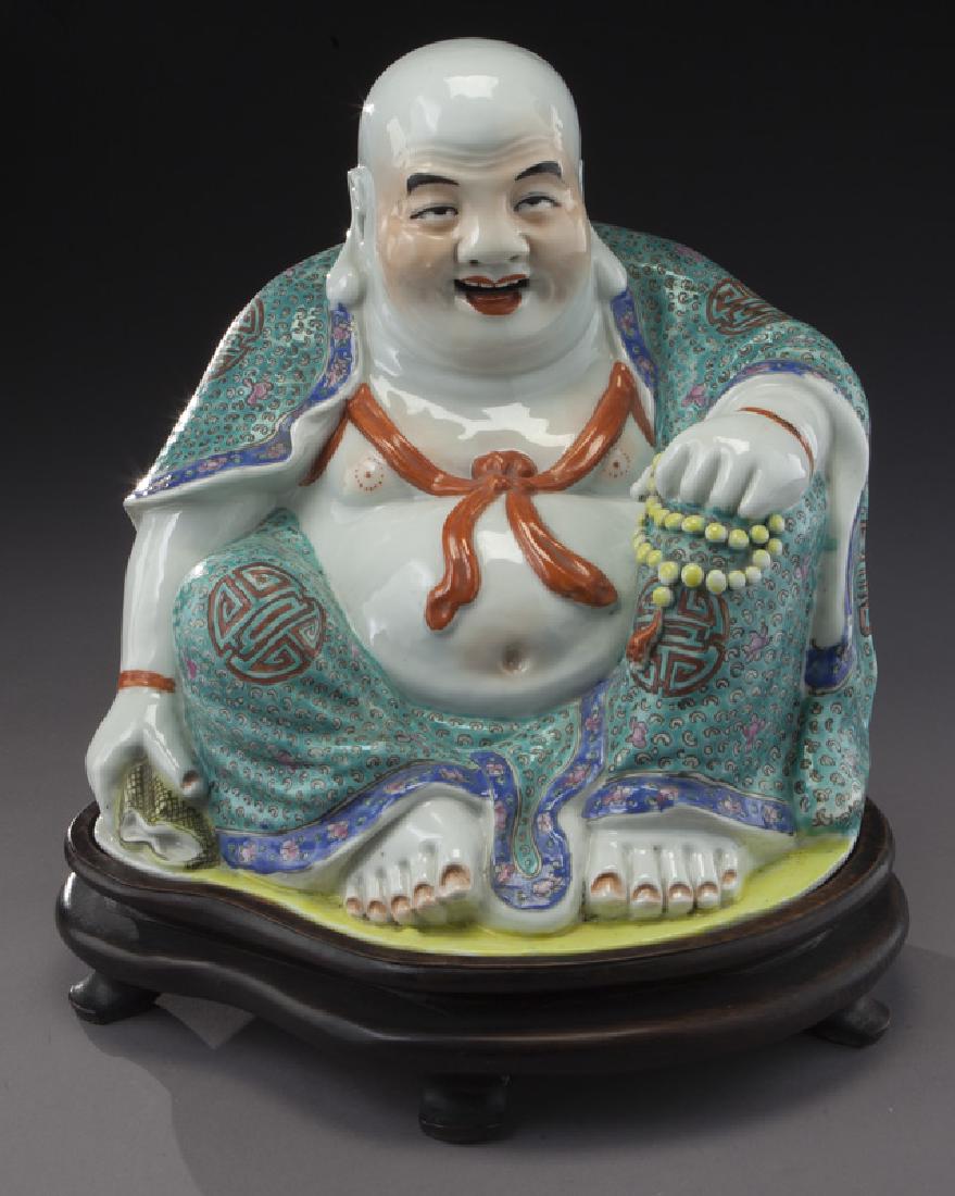 Chinese Qing famille rose Budai Buddha,: Chinese Qing famille rose Budai Buddha, marked Fu Jian Hui Guan and You Lin Ji made, raised on a rosewood stand. Buddha: 10.5"H x 10.5"W x 8"D, Circa - Late 19th C./Early 20th C.