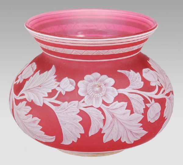 English cameo glass vase by Thomas Webb: having a squatty form of cranberry glass overlaid in white cut with floral motif and butterfly. Unsigned. 4.75"H x 6"Dia., Circa - 1885-1910.