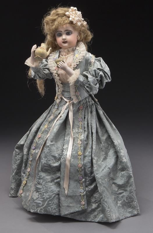 French Tete Jumeau automaton of lady drinking tea,: French Tete Jumeau automaton of lady drinking tea, the bisque head figure with brown glass eyes, painted eyebrows and eyelashes and with open mouth, moveable tongue and old mohair wig, standing on a r