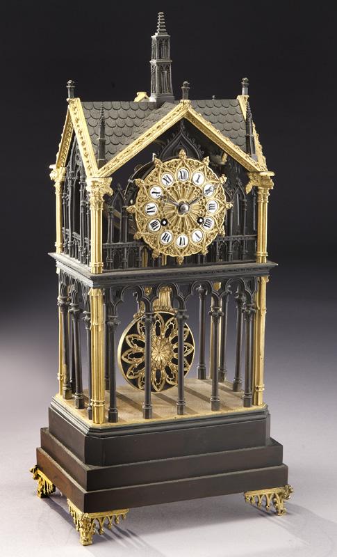 Unusual French gilt & patinated bronze shelf clock: Unusual French gilt & patinated bronze shelf clock in an architectural "Gothic" style skeletonized case decorated with gargoyle heads. The dial and pendulum decorated like Gothic windows. The circular