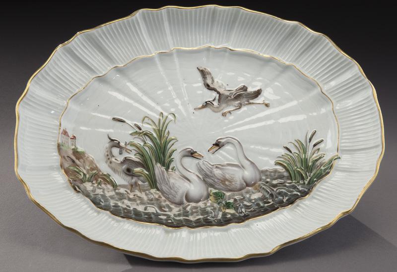 Meissen oval platter in the decorated "Swan": Meissen oval platter in the decorated "Swan" pattern with scalloped border and gilt trim. With blue underglaze crossed swords mark. 12"L x 9"W, Circa - Mid 19th C.