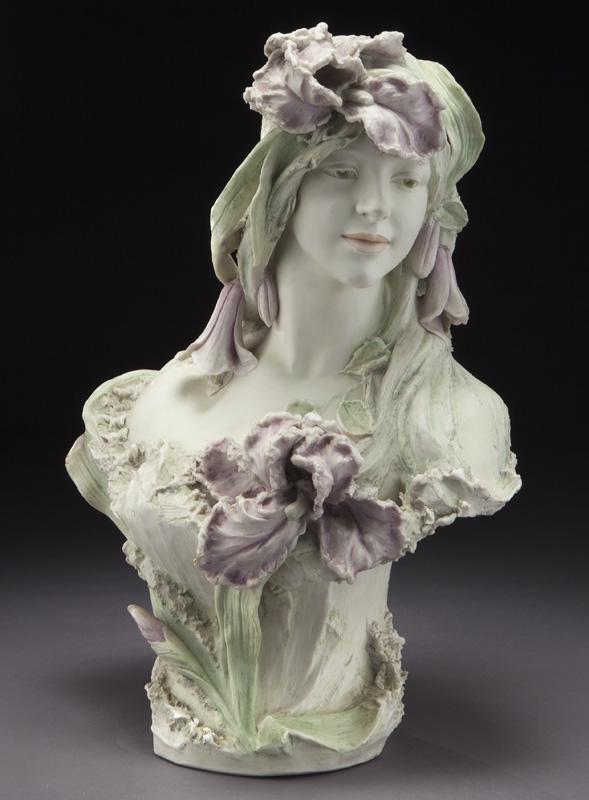 Royal Dux Bohemia bust of a female: Royal Dux Bohemia bust of a female adorned with purple flowers and green foliage. Underside marked, "Royal Dux Bohemia / 506 / 11". 20.25"H x 14.5"W x 9.25"D, Circa - 1900. PROVENANCE: Property from t
