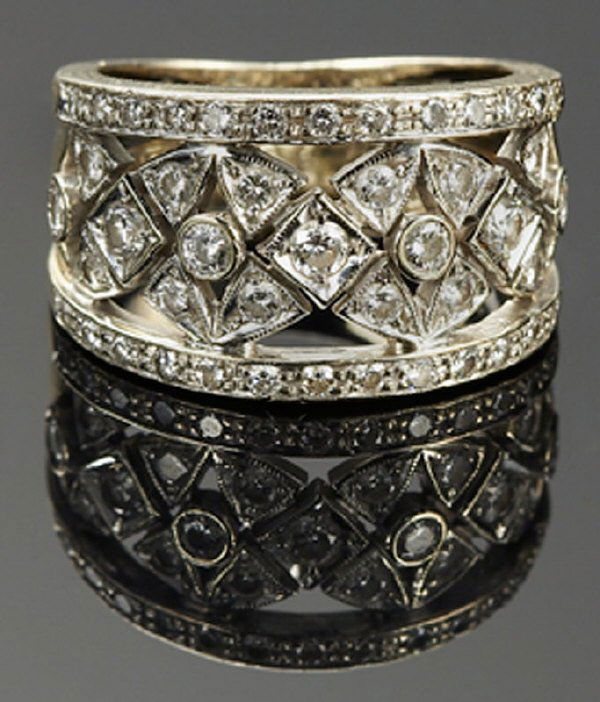 Chimento 18K gold and diamond ring: having 45 round brilliant cut diamonds, .86 cts. approximate, G-H color, VS2-SI1 clarity. 6.8 grams. Marked. "750 chimento 408v1". Size 4.5. Circa - Fourth quarter 20th C.