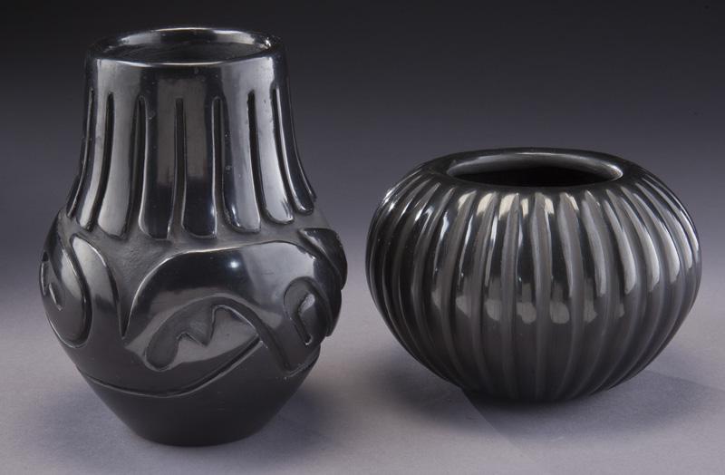 (2) Blackware vases,: (2) Blackware vases, including: (1) with Avanyu motif. Signed to underside, "Stella Chavarrio / Santa Clara" and (1) with ribbed pattern. Signed to underside, "Angela Baca". Taller: 7"H, Circa - 20th 