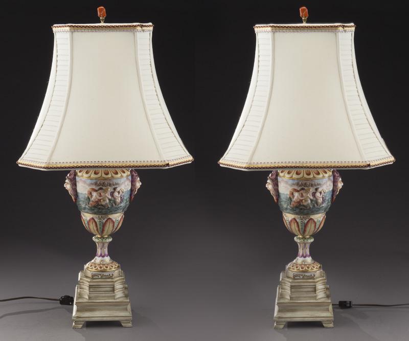 Pr. Capodimonte table lamps with shades,: Pr. Capodimonte table lamps with shades, the baluster form featuring classical nudes and flanking mask handles, raised on footed wood base. 31.75"H x 6" Sq. base, Circa - Late 19th / Early 20th C.