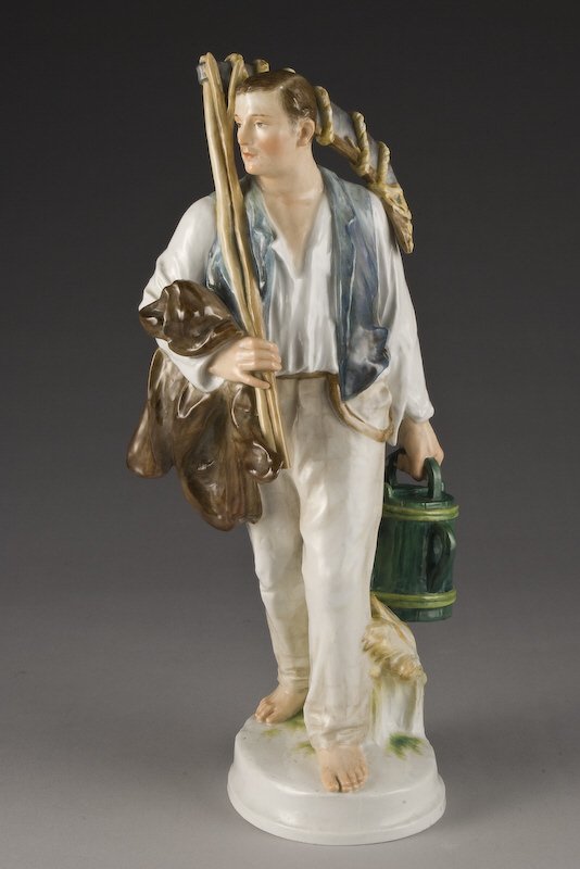 Rare Meissen porcelain figural of a farmer: walking barefoot, carrying a scythe and coat in one arm and bucket in the other, on a oval white mound. Indistinctly incised, "U134", pressmark, "76", blue cross-swords mark under glaze.14.5"H, Circa 