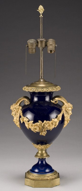 French Sevres style porcelain urn: with gilt bronze satyr head handles joined on one side with a floral swag. Now fashioned as a lamp. top of urn- 16.5"H, Circa - Late 19th C.