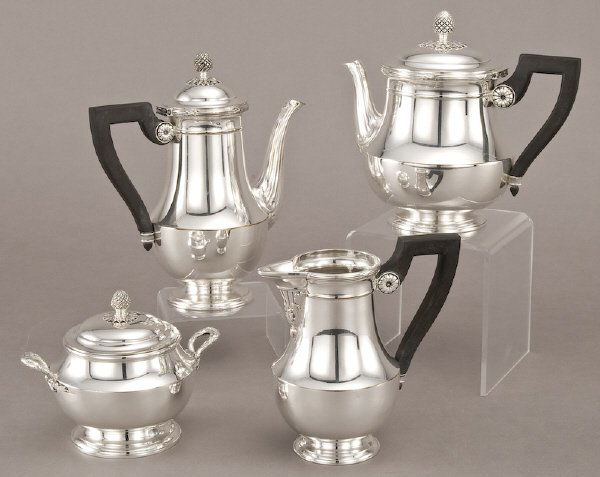 4 Pcs. Christofle silver plate tea service: including: a teapot, coffee pot, creamer and covered sugar, having ebonized wood handles and pineapple finials. Marked, "Christofle" and "18", "20", "21" or "28". Tallest: 9"H, Circa - 20th C.